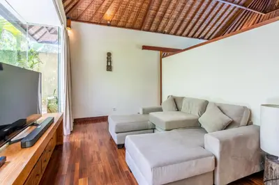 a living room with a couch and a flat screen tv at Villa Ku Besar by Villa Finder in Dalung