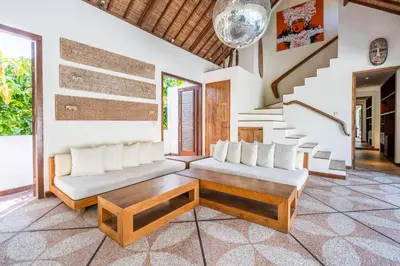 a living room with two couches and a table at Villa Ku Tama by Villa Finder in Seminyak