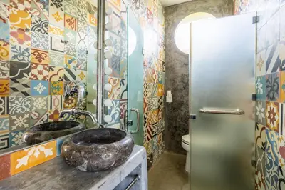 a bathroom with two sinks and a shower at Villa Ku Tama by Villa Finder in Seminyak