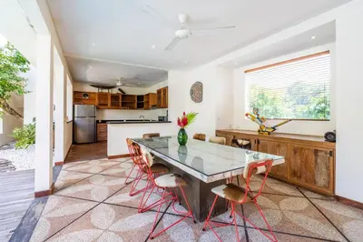 a kitchen and dining room with a table and chairs at Villa Ku Tama by Villa Finder in Seminyak