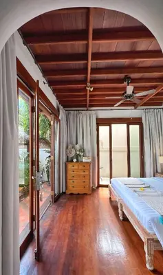 a bedroom with a bed and a wooden floor at Villa Nicole 5BR Paradise, quiet area in Central Oberoi Seminyak in Seminyak
