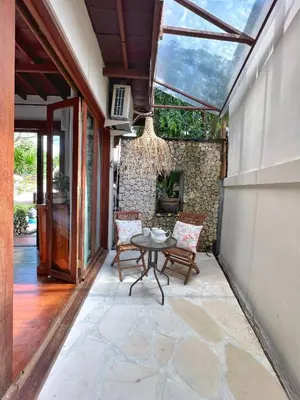 a patio with a table and chairs and a chandelier at Villa Nicole 5BR Paradise, quiet area in Central Oberoi Seminyak in Seminyak
