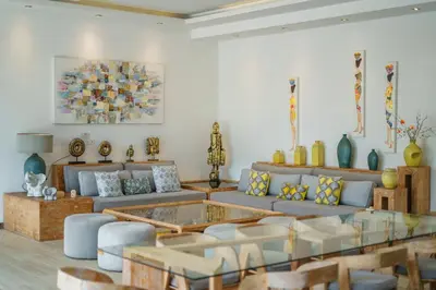 a living room with a couch and a table at Villa Harlow: Stylish 3BR Villa - Centrally Located in Berawa in Canggu