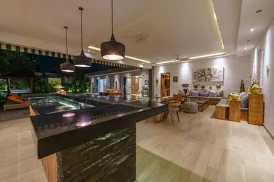 a large room with a pool and a living room at Villa Harlow: Stylish 3BR Villa - Centrally Located in Berawa in Canggu