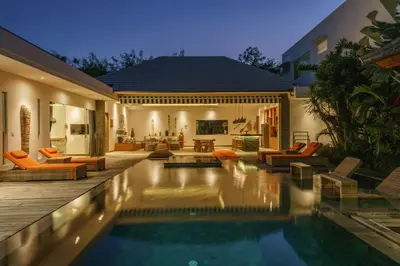 a house with a swimming pool in front of a house at Villa Harlow: Stylish 3BR Villa - Centrally Located in Berawa in Canggu