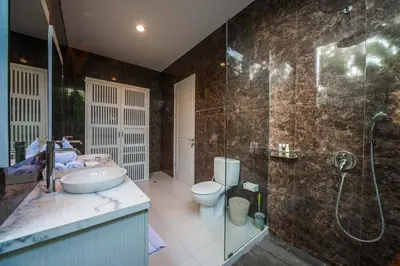 a bathroom with a sink and a shower and a toilet at Superb 3 Bed Villa, Walk to Beach, Fast Wi-Fi, in Seminyak