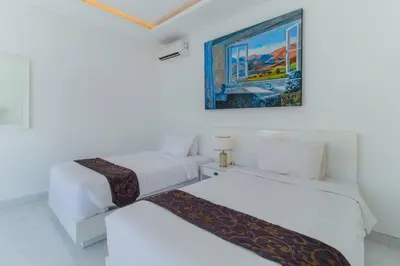 a room with two beds and a painting on the wall at Superb 3 Bed Villa, Walk to Beach, Fast Wi-Fi, in Seminyak