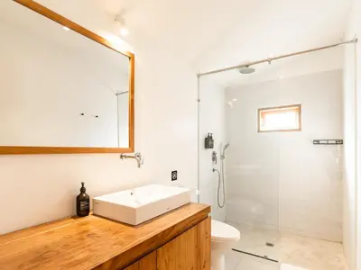 a bathroom with a sink and a shower at Berawa Village Suite in Canggu