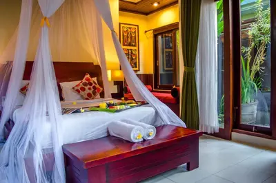 a bedroom with a bed with a mosquito net at The Bali Dream Suite Villa Seminyak in Seminyak