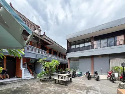 a group of motorcycles parked next to a building at RedDoorz at Mahendra Beach Inn Kuta in Kuta