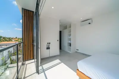 a bedroom with a bed and a balcony at Villa Vantage 7 - Outstanding 3 BR Villa - Great Location! in Canggu