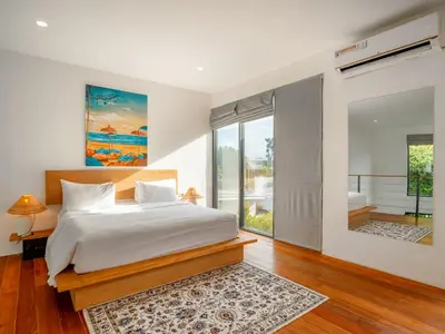 a bedroom with a bed and a large window at Umalas Living Villa in Canggu