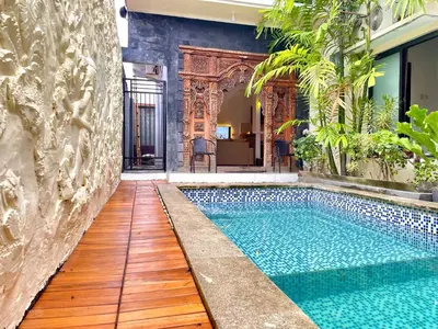 a swimming pool in the middle of a house at Satran Villa @ Kuta Bali in Legian