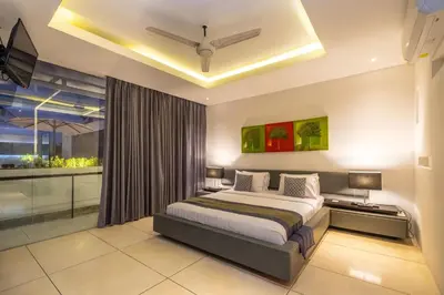 a bedroom with a bed and a large window at Villa Aqua Seminyak in Seminyak
