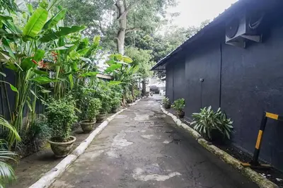 an alley with potted plants next to a building at Kos 168 Jimbaran in Jimbaran