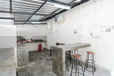 a kitchen with a counter and stools in a room at Kos 168 Jimbaran in Jimbaran