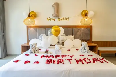 a bed with balloons and a happy birthday sign on it at Casa Wina Kuta by The Wina Resorts in Kuta