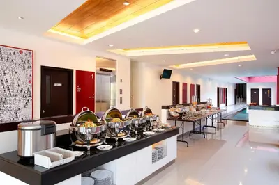 a restaurant with a buffet line with plates of food at Amaris Hotel Dewi Sri - Bali in Legian