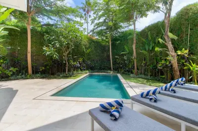 a swimming pool with two lounge chairs next to it at Fantastic 3 Bed Villa, Walk to Beach, Sunny Pool in Seminyak