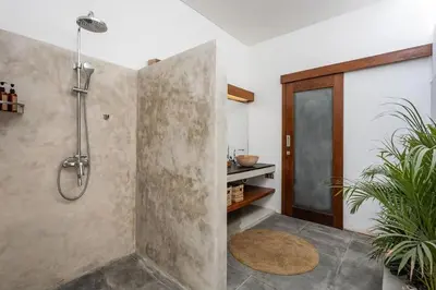 a bathroom with a shower with a glass door at Villa Bahia by Optimum Bali Villas in Seminyak