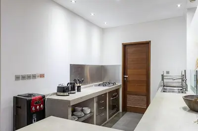 a kitchen with a sink and a stove top oven at Villa Bahia by Optimum Bali Villas in Seminyak
