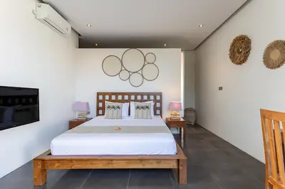 a bedroom with a bed and two olympics on the wall at Villa Bahia by Optimum Bali Villas in Seminyak
