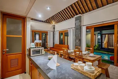 a kitchen and living room with a table and a microwave at 4BR w/ Pool- Ultimate Comfort in Umalas in Kerobokan