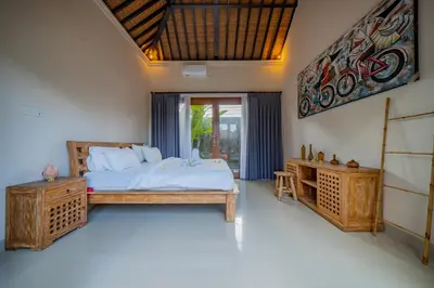 a bedroom with a bed and a window at 4BR w/ Pool- Ultimate Comfort in Umalas in Kerobokan