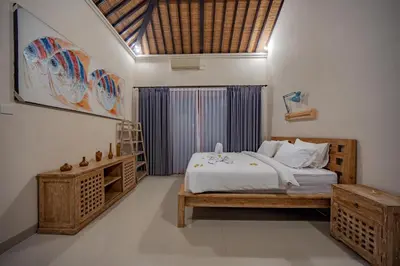 a bedroom with a large bed and a window at 4BR w/ Pool- Ultimate Comfort in Umalas in Kerobokan