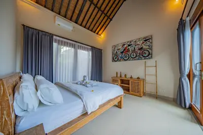 a bedroom with a large bed and a window at 4BR w/ Pool- Ultimate Comfort in Umalas in Kerobokan