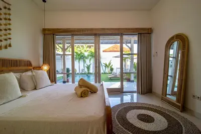 a bedroom with a bed with a stuffed animal on it at Simple & Magical Villas PRAYA in Seminyak