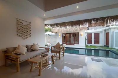 a living room with a couch and a pool at Simple & Magical Villas. Villa Sambali llI in Seminyak