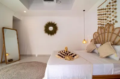 a bedroom with a bed and a mirror at Simple & Magical Villas. Villa Sambali llI in Seminyak