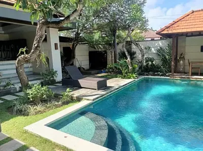 a swimming pool in the yard of a house at Villa alula in Seminyak