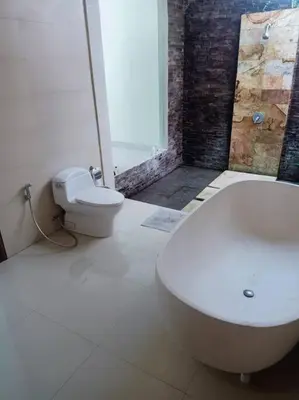 a bathroom with a white toilet and a sink at Villa alula in Seminyak