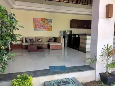 a living room with a couch and a kitchen at Villa alula in Seminyak