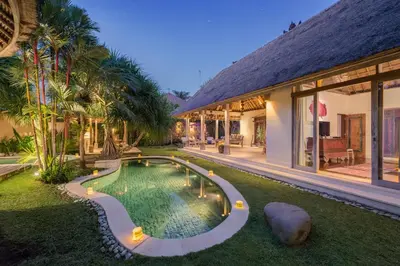 an external view of a house with a swimming pool at The Tirta Naga Villas in Seminyak