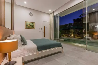 a bedroom with a bed and a large window at Villa Serenity: modern design luxury 12m pool and BBQ in Seminyak