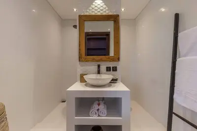 a white bathroom with a sink and a mirror at Villa Budha 2 4bedrs 12m Pool, 700m2 garden&BBQ, central & quiet in Seminyak