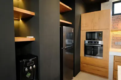 a kitchen with a stainless steel refrigerator and a microwave at Manresa Villa Bali 2 in Canggu
