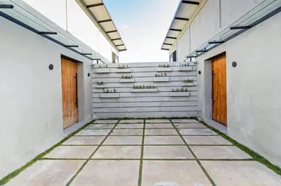 an empty corridor of a building with two doors at Manresa Villa Bali 2 in Canggu