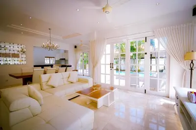 a living room with a white couch and a table at Kencana Villa Seminyak in Seminyak
