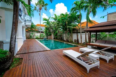 a swimming pool in the middle of a house at Kencana Villa Seminyak in Seminyak
