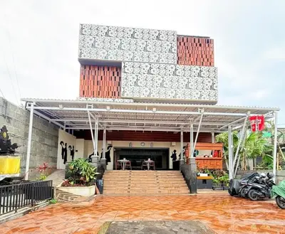 a building with a patio with a table in it at Kimono Spa Hotel in Kuta