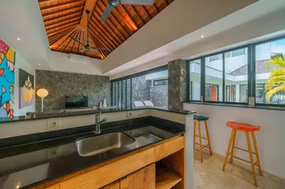 a kitchen with a sink and a counter top at Villa Yasmee : Cozy and Modern 2 BR w/ Pool in Seminyak ! in Seminyak
