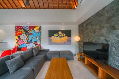 a living room with a couch and a fireplace at Villa Yasmee : Cozy and Modern 2 BR w/ Pool in Seminyak ! in Seminyak