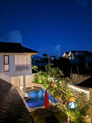 a backyard with a swimming pool next to a house at Javine Villa - by Unicorn Villas Bali in Canggu