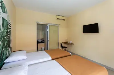 a bedroom with a bed and a tv on the wall at Cove Kanaya in Denpasar