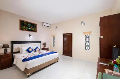 a bedroom with a large bed in a room at Lumbung Sari Hotel Legian in Legian