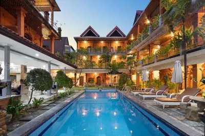an indoor pool in a house with a resort at Lumbung Sari Hotel Legian in Legian